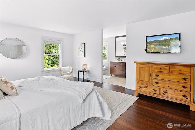 1014 Cherry Ave NE, Bainbridge Island, WA 98110 - bedroom with wood finished floors, multiple windows, ensuite bath, and baseboards