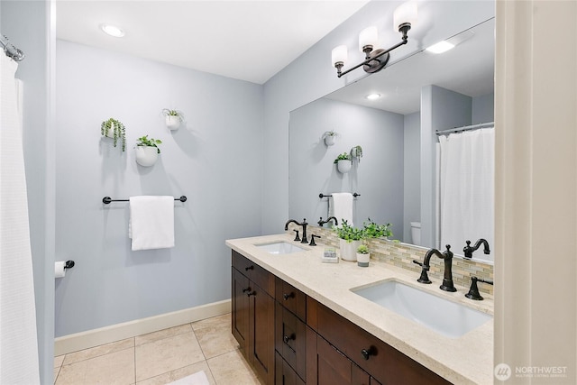 1014 Cherry Ave NE, Bainbridge Island, WA 98110 - bathroom featuring baseboards, toilet, tile patterned floors, double vanity, and recessed lighting