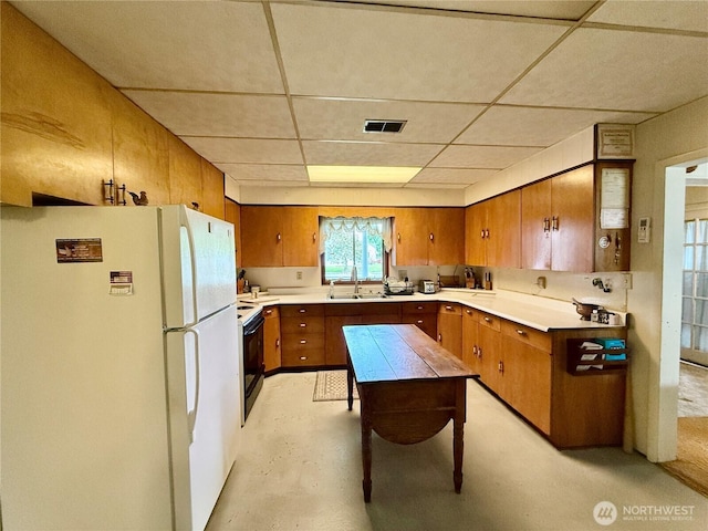303307 N 3rd St, Dayton, WA 99328 - kitchen featuring freestanding refrigerator, brown cabinetry, a sink, electric stove, and a drop ceiling