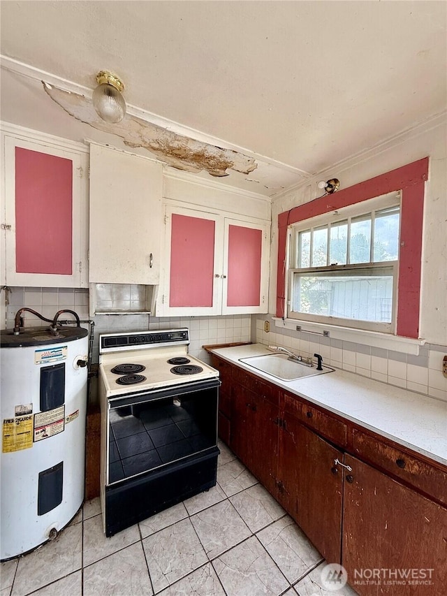 303307 N 3rd St, Dayton, WA 99328 - kitchen with electric range oven, water heater, a sink, and tasteful backsplash