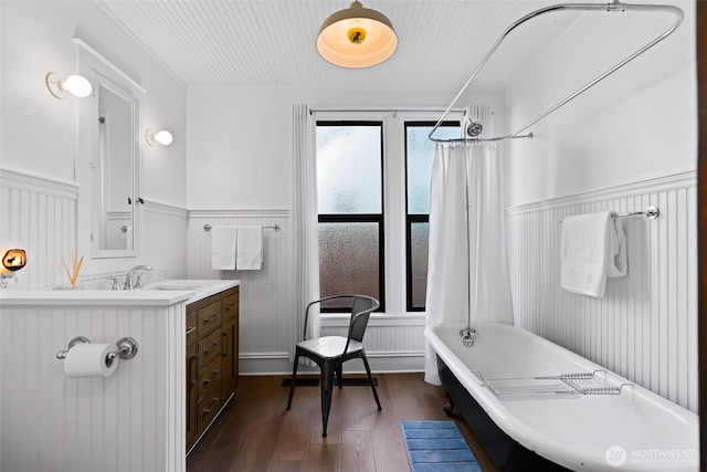 605 N Sampson St, Ellensburg, WA 98926 - full bath featuring wainscoting, a freestanding tub, wood finished floors, vanity, and a shower with curtain