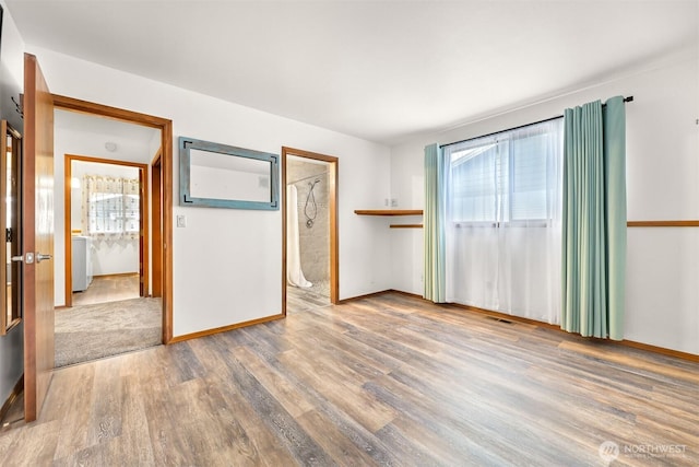 8061 Niska Rd, Blaine, WA 98230 - empty room with plenty of natural light, wood finished floors, and baseboards