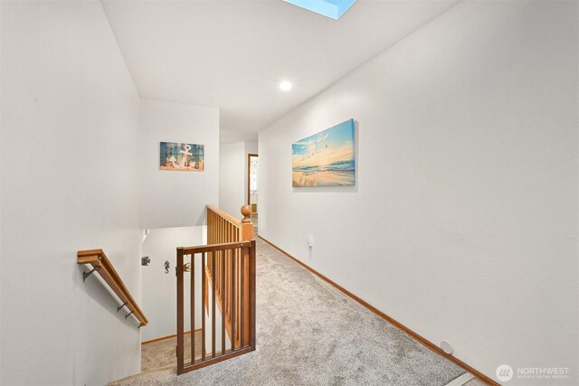8061 Niska Rd, Blaine, WA 98230 - hall featuring an upstairs landing, carpet, baseboards, a skylight, and recessed lighting