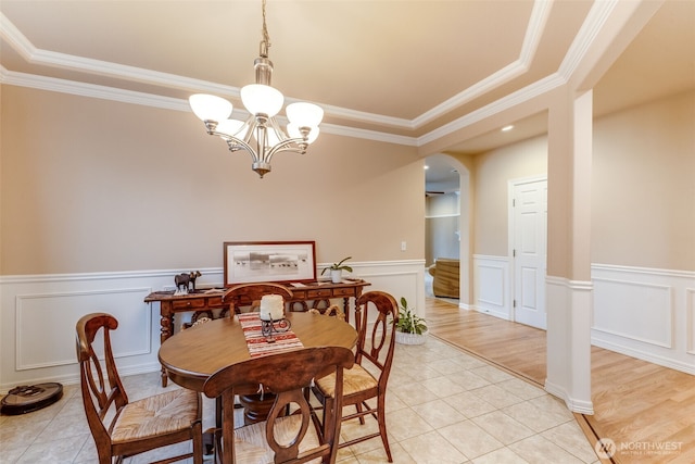 30630 122nd Ave SE, Auburn, WA 98092 - dining room featuring ornamental molding, a chandelier, light tile patterned floors, arched walkways, and a wainscoted wall