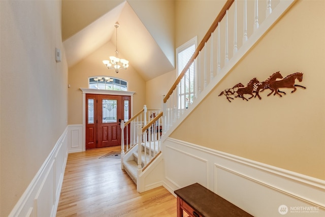 30630 122nd Ave SE, Auburn, WA 98092 - entryway featuring a decorative wall, a chandelier, stairway, light wood finished floors, and high vaulted ceiling