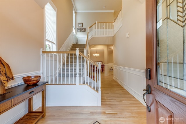 30630 122nd Ave SE, Auburn, WA 98092 - stairs with a decorative wall, wood finished floors, a wainscoted wall, crown molding, and a chandelier
