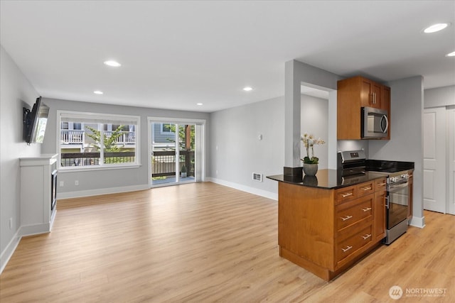 21307 48th Ave W Unit C206, Mountlake Terrace, WA 98043 - kitchen with appliances with stainless steel finishes, light wood finished floors, brown cabinetry, dark countertops, and recessed lighting