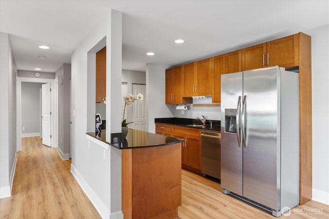 21307 48th Ave W Unit C206, Mountlake Terrace, WA 98043 - kitchen featuring stainless steel appliances, dark countertops, light wood-type flooring, brown cabinetry, and recessed lighting