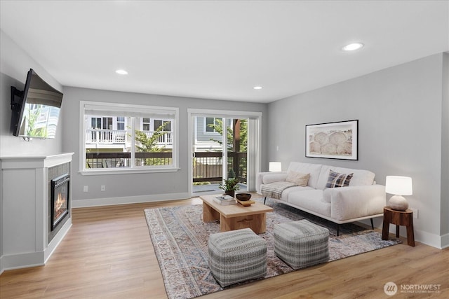 21307 48th Ave W Unit C206, Mountlake Terrace, WA 98043 - living area featuring light wood-style floors, baseboards, a tile fireplace, and recessed lighting