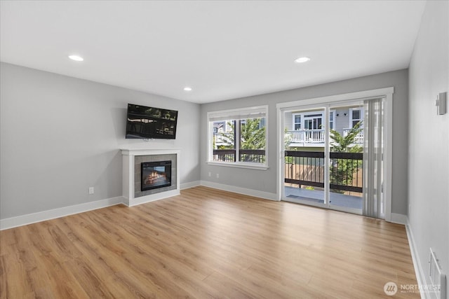 21307 48th Ave W Unit C206, Mountlake Terrace, WA 98043 - unfurnished living room with light wood finished floors, a fireplace, baseboards, and recessed lighting