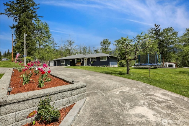 16015 Lange Rd, Mount Vernon, WA 98273 - ranch-style home featuring a trampoline, a front lawn, and driveway