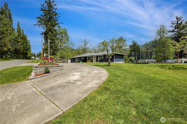 16015 Lange Rd, Mount Vernon, WA 98273 - view of front of property featuring a trampoline, curved driveway, and a front lawn