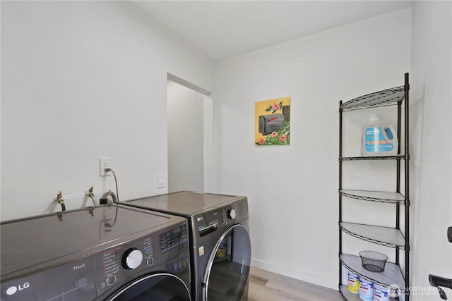 16015 Lange Rd, Mount Vernon, WA 98273 - washroom featuring independent washer and dryer, light wood-style floors, and baseboards