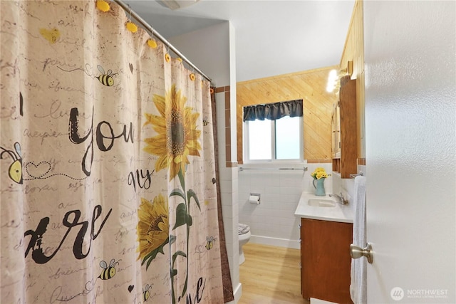 16015 Lange Rd, Mount Vernon, WA 98273 - bathroom featuring toilet, vanity, tile walls, wood finished floors, and a shower with shower curtain