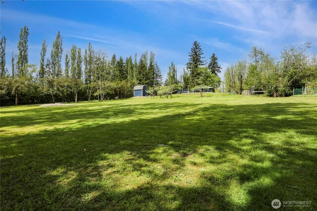 16015 Lange Rd, Mount Vernon, WA 98273 - view of grassy yard featuring a storage shed
