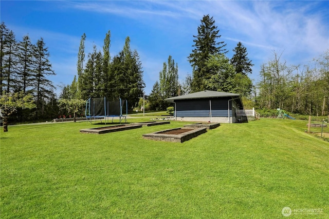 16015 Lange Rd, Mount Vernon, WA 98273 - view of grassy yard with a trampoline, a playground, and view of scattered trees