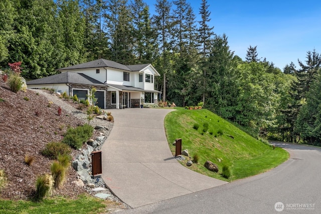 1048 Malvern Hills Dr, Camano Island, WA 98282 - view of front of home with concrete driveway, stone siding, covered porch, and a front lawn