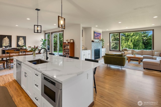 1048 Malvern Hills Dr, Camano Island, WA 98282 - kitchen featuring a sink, stainless steel appliances, open floor plan, light wood finished floors, and healthy amount of natural light