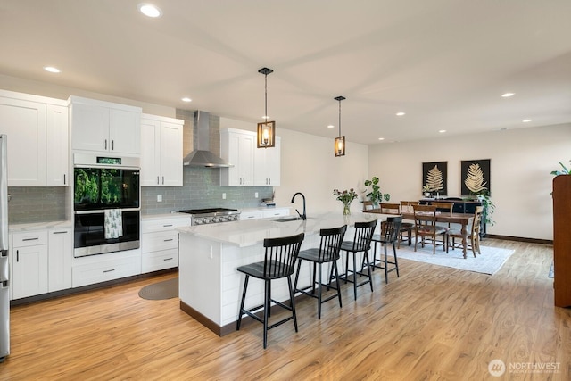 1048 Malvern Hills Dr, Camano Island, WA 98282 - kitchen with wall chimney range hood, stainless steel double oven, a sink, light countertops, and recessed lighting