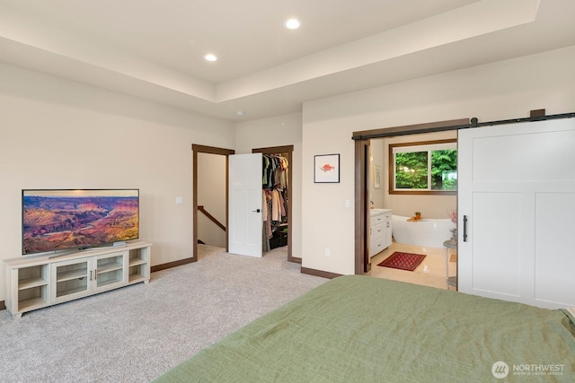 1048 Malvern Hills Dr, Camano Island, WA 98282 - carpeted bedroom featuring a spacious closet, recessed lighting, baseboards, connected bathroom, and a barn door