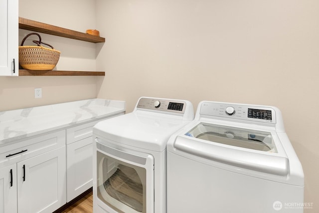 1048 Malvern Hills Dr, Camano Island, WA 98282 - washroom with washing machine and dryer, cabinet space, and wood finished floors