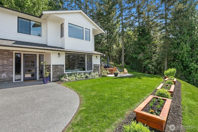 1048 Malvern Hills Dr, Camano Island, WA 98282 - view of grassy yard featuring a garden and a patio area