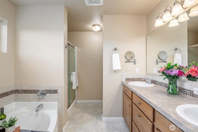 7628 Kodiak Ave NE, Lacey, WA 98516 - bathroom featuring a bath, double vanity, and a stall shower
