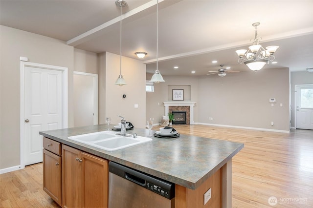 7628 Kodiak Ave NE, Lacey, WA 98516 - kitchen featuring stainless steel dishwasher, ceiling fan, light wood-style floors, an island with sink, and open floor plan
