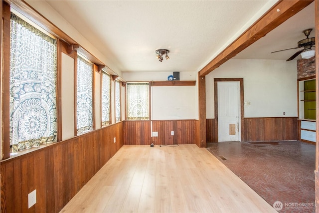 400 Augustus St, Toledo, WA 98591 - spare room with a wainscoted wall, wood walls, ceiling fan, and wood finished floors