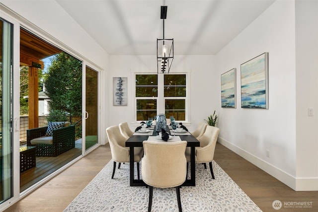 dining space with wood finished floors and baseboards
