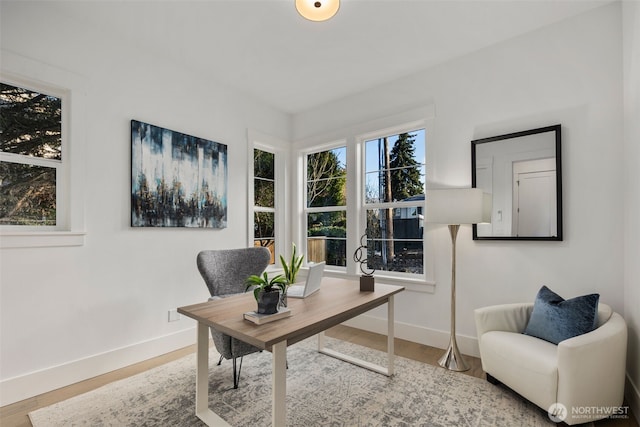 home office with baseboards and wood finished floors