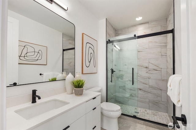 bathroom with a shower stall, vanity, toilet, and recessed lighting
