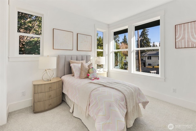 carpeted bedroom featuring baseboards