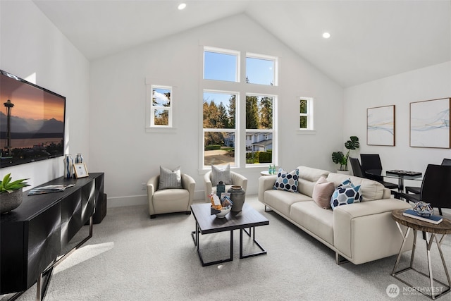 living area featuring light colored carpet, recessed lighting, high vaulted ceiling, and baseboards