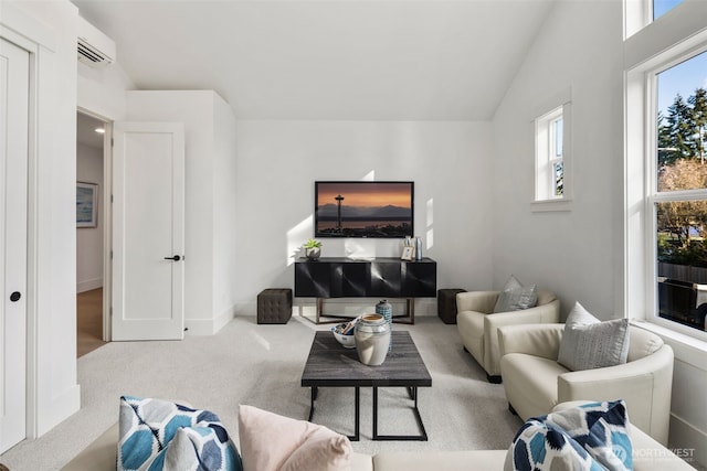 carpeted living area with lofted ceiling, plenty of natural light, a wall unit AC, and baseboards