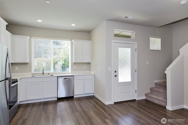1308 E 53rd St, Tacoma, WA 98404 - kitchen with appliances with stainless steel finishes, dark wood finished floors, a sink, light countertops, and recessed lighting