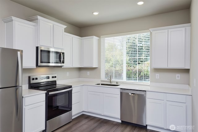 1308 E 53rd St, Tacoma, WA 98404 - kitchen with stainless steel appliances, a sink, white cabinets, light countertops, and recessed lighting