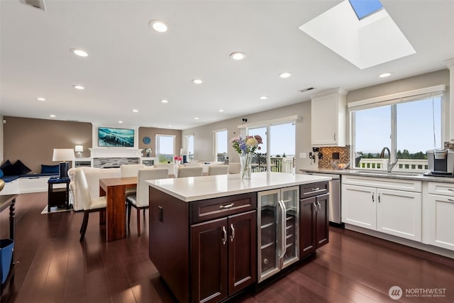 4019 N Vassault St, Tacoma, WA 98407 - kitchen featuring beverage cooler, open floor plan, light countertops, white cabinets, and dark wood-style floors