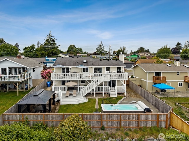 4019 N Vassault St, Tacoma, WA 98407 - back of house with a deck, a fenced backyard, a residential view, stairs, and a pool