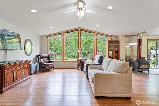 25420 354th Ave SE, Ravensdale, WA 98051 - living area with lofted ceiling, a wood stove, a ceiling fan, light wood-style flooring, and recessed lighting