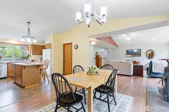 25420 354th Ave SE, Ravensdale, WA 98051 - dining room with lofted ceiling, light wood-style flooring, a chandelier, and a ceiling fan