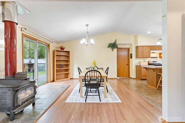 25420 354th Ave SE, Ravensdale, WA 98051 - dining space featuring vaulted ceiling, light wood-style flooring, a wood stove, and a chandelier