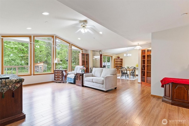 25420 354th Ave SE, Ravensdale, WA 98051 - living room with lofted ceiling, a ceiling fan, light wood-style flooring, a chandelier, and baseboards