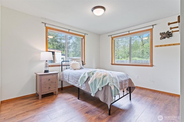 25420 354th Ave SE, Ravensdale, WA 98051 - bedroom with multiple windows, light wood-style floors, and baseboards
