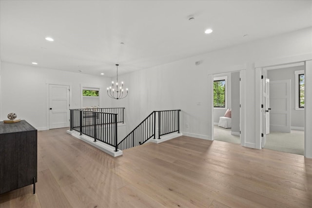11440 109th Ave NE, Kirkland, WA 98033 - spare room with a chandelier, healthy amount of natural light, recessed lighting, light wood-type flooring, and baseboards