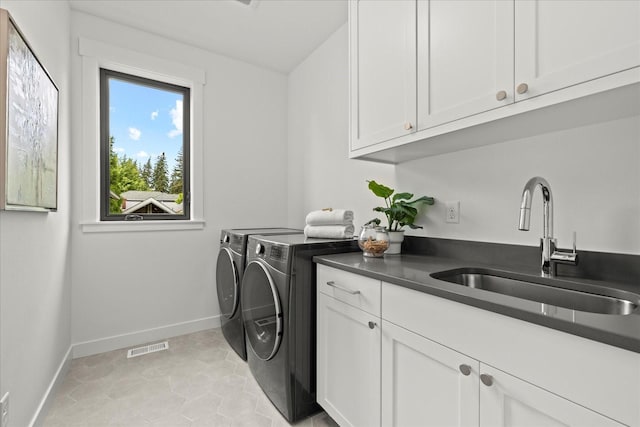 11440 109th Ave NE, Kirkland, WA 98033 - laundry room with cabinet space, washer and clothes dryer, baseboards, and light tile patterned flooring