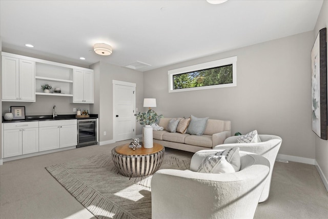 11440 109th Ave NE, Kirkland, WA 98033 - living area featuring beverage cooler, light colored carpet, bar with sink, baseboards, and recessed lighting