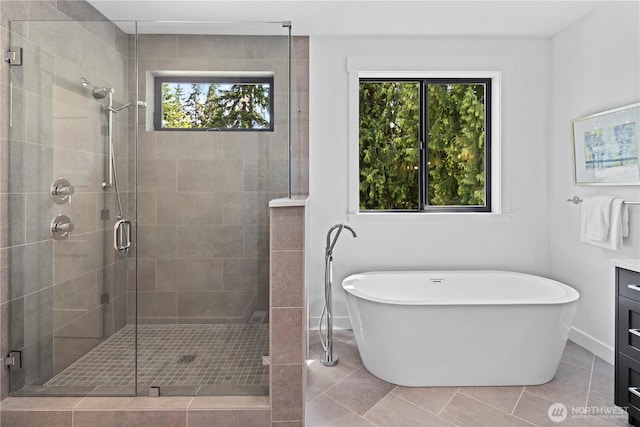 11440 109th Ave NE, Kirkland, WA 98033 - bathroom with healthy amount of natural light, a soaking tub, a shower stall, and tile patterned floors