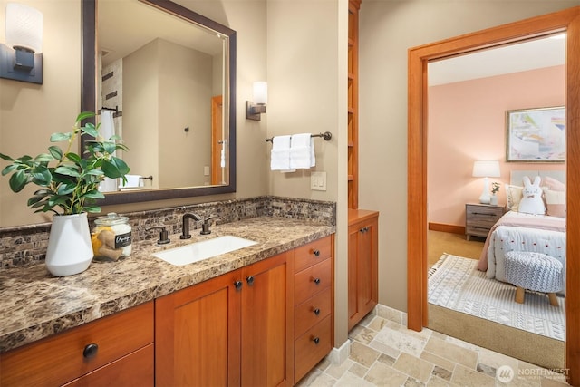 26970 SE Old Black Nugget Rd, Issaquah, WA 98029 - bathroom featuring vanity, baseboards, and stone finish floors