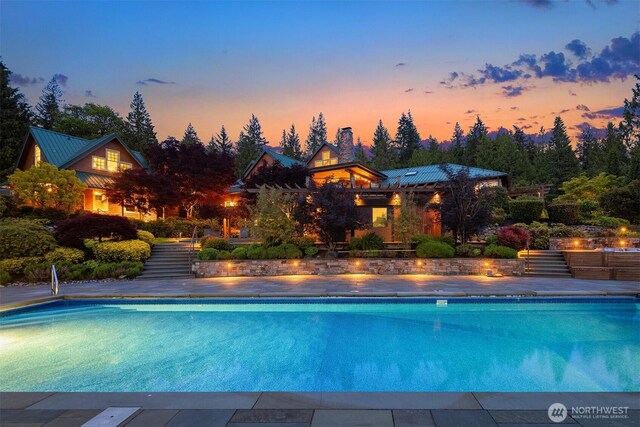26970 SE Old Black Nugget Rd, Issaquah, WA 98029 - pool at dusk featuring an outdoor pool and stairs